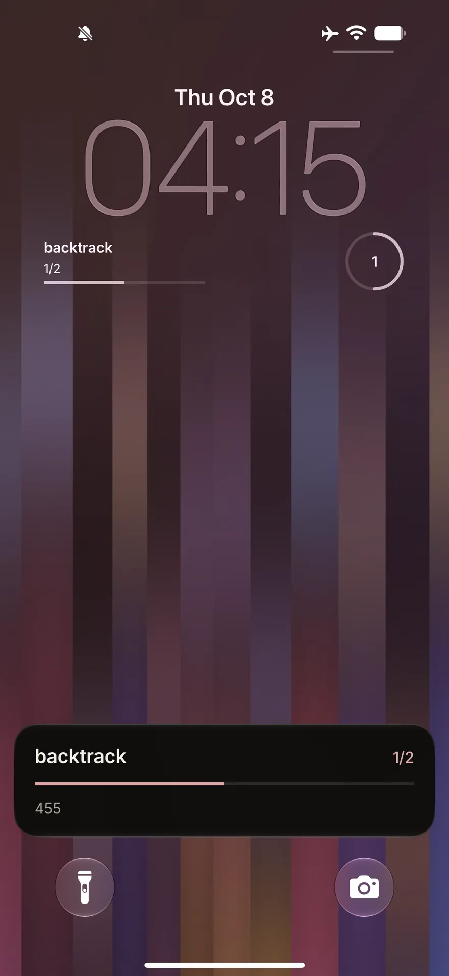 The iPhone Lock Screen: Backtrack’s Lock Screen widgets show a checklist at 1 of 2, and its Live Activity at the foot shows the same count with a progress bar.